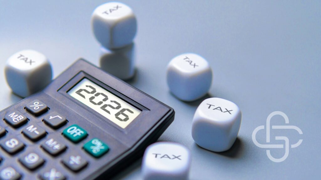 Calculator with 2026 on it and a set of dice with tax on them.