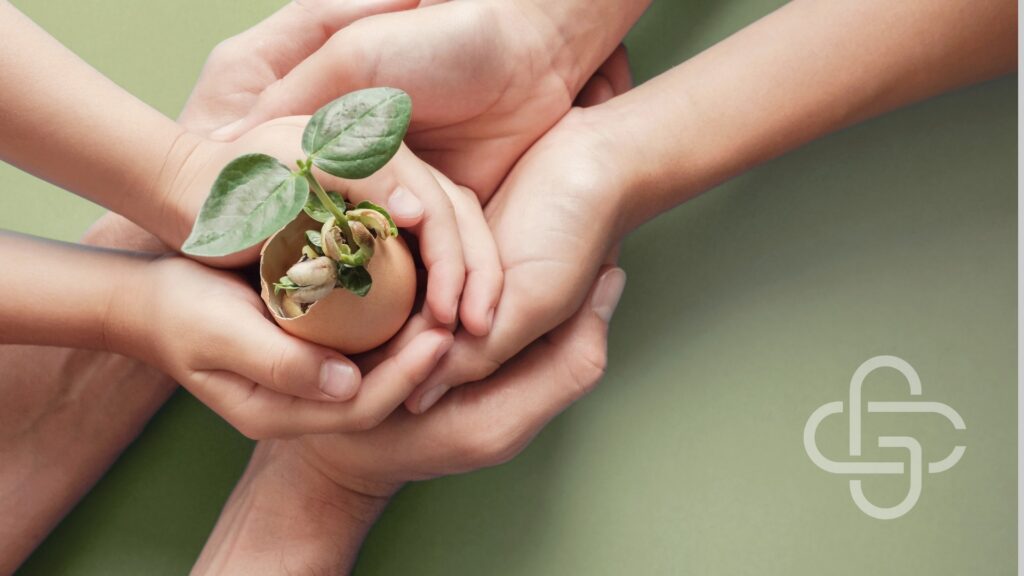 Kids and adult holding seedling plant