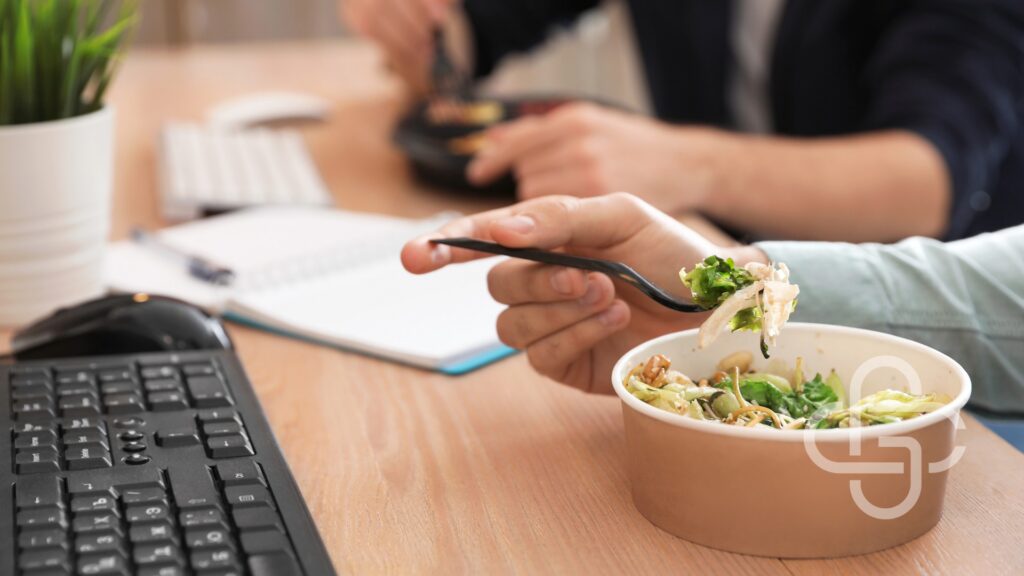 Employee eating lunch at a desk